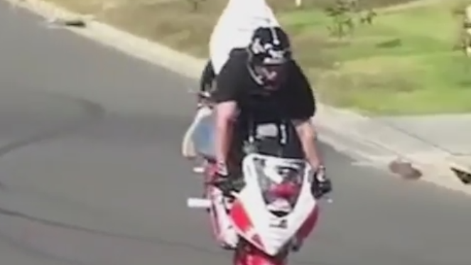 Stunt rider rolling stoppie